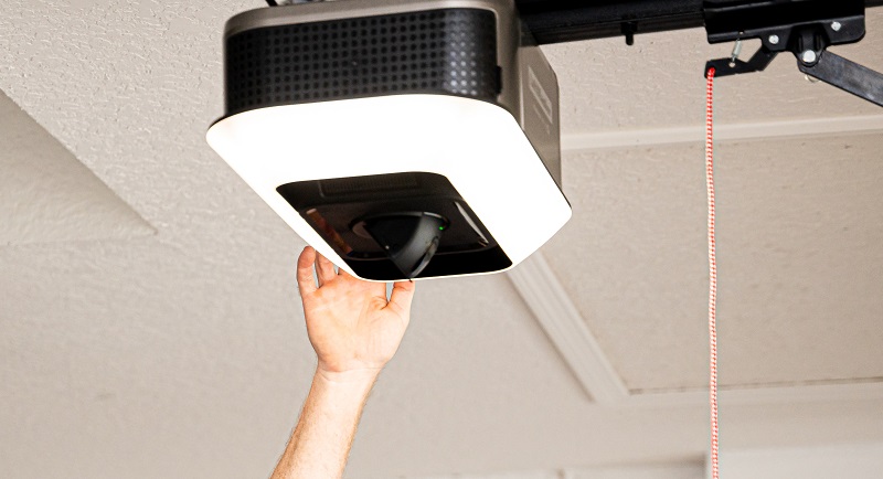 person inspecting LiftMaster garage door opener