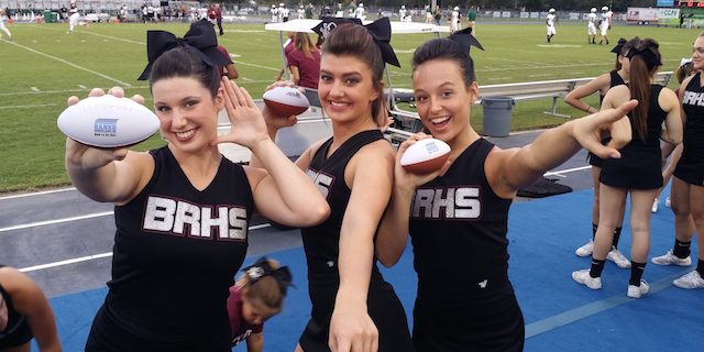 Three Cheerleaders in the Football Field